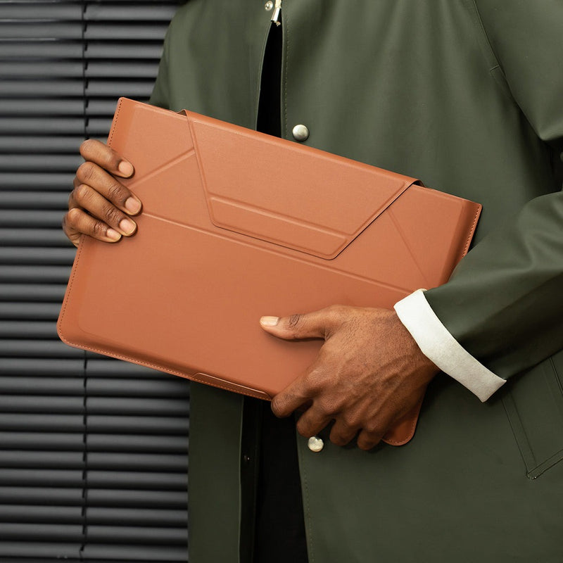 MOFT - Laptop Carry Sleeve 輕薄三合一 隱形立架筆電包 held by a person in a stylish outfit.